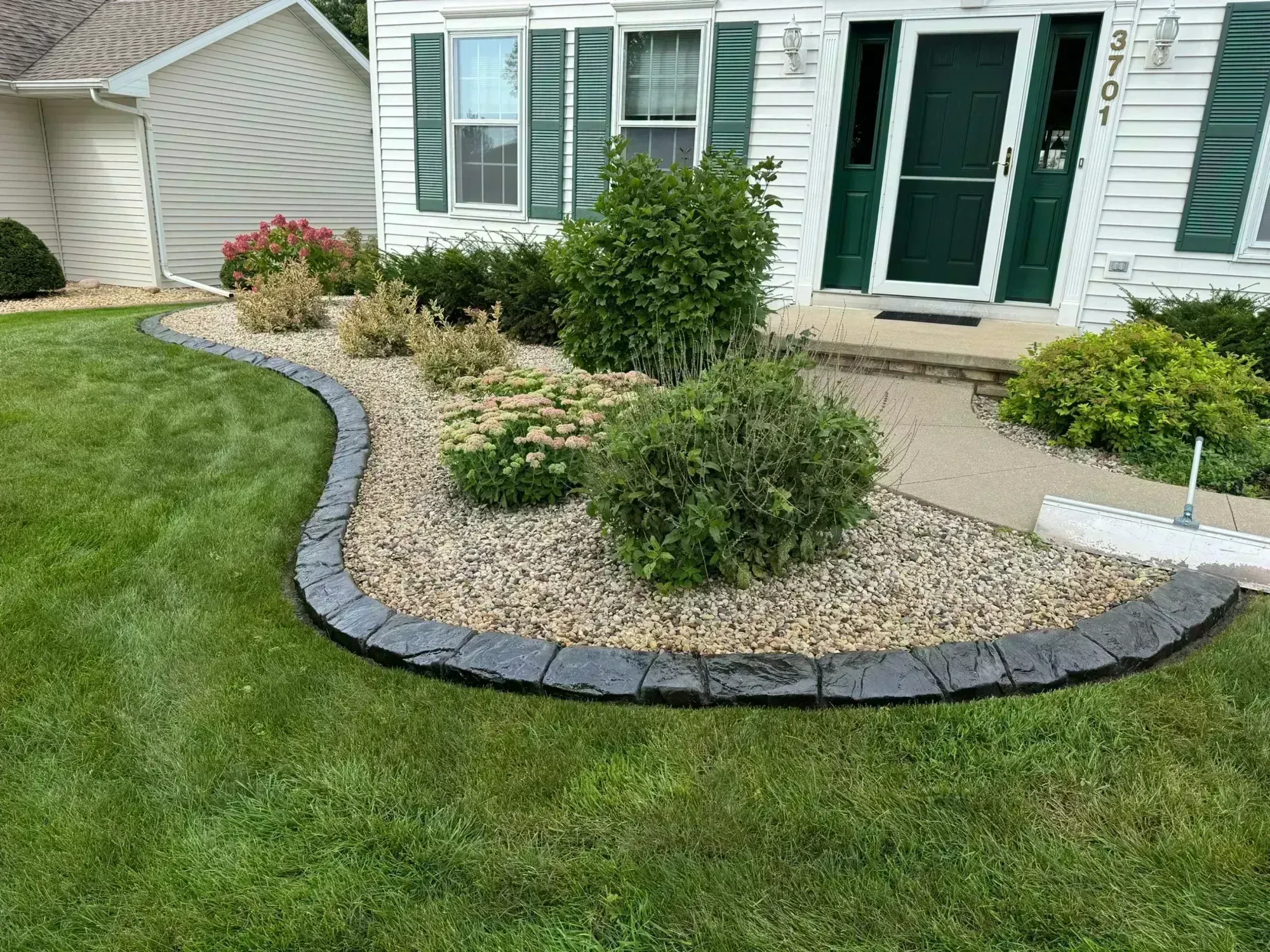 Concrete landscape curbing along a garden bed in Eagle River, WI Concrete landscape curbing along a garden bed in Eagle River, WI