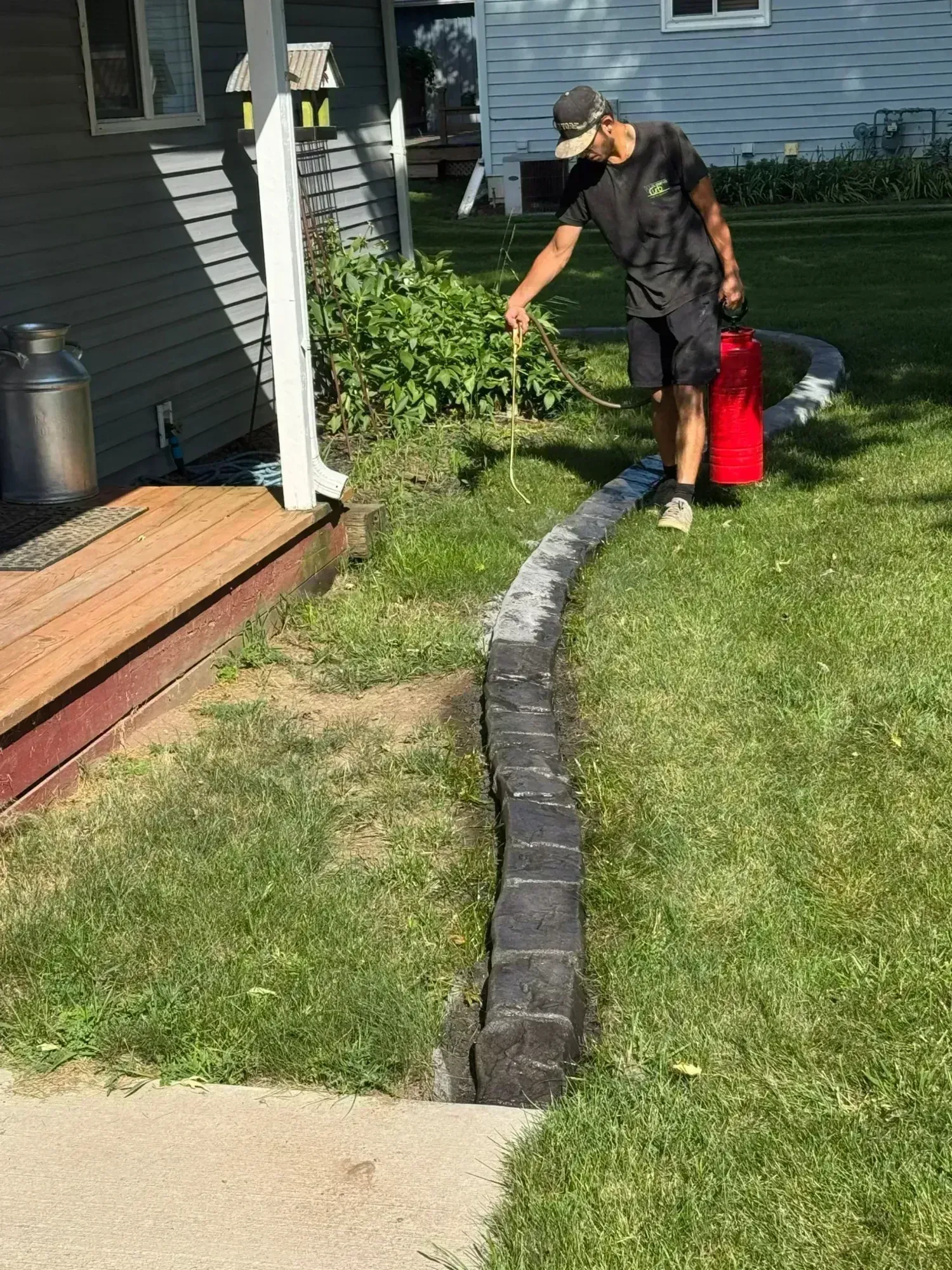 Straight curbing along driveway with ornamental grasses