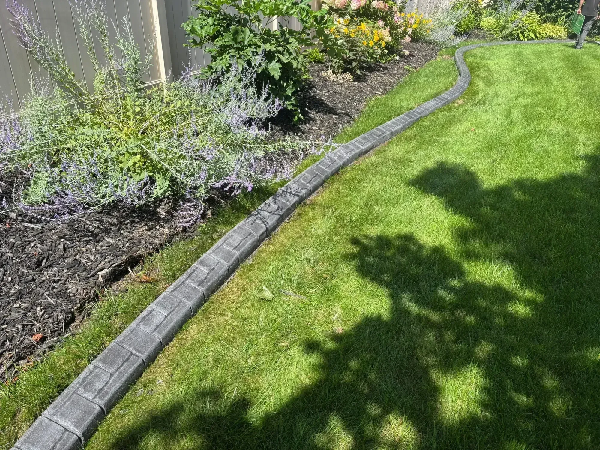 Professional landscape curbing tools and equipment on a Wisconsin residential property Professional landscape curbing tools and equipment on a Wisconsin residential property