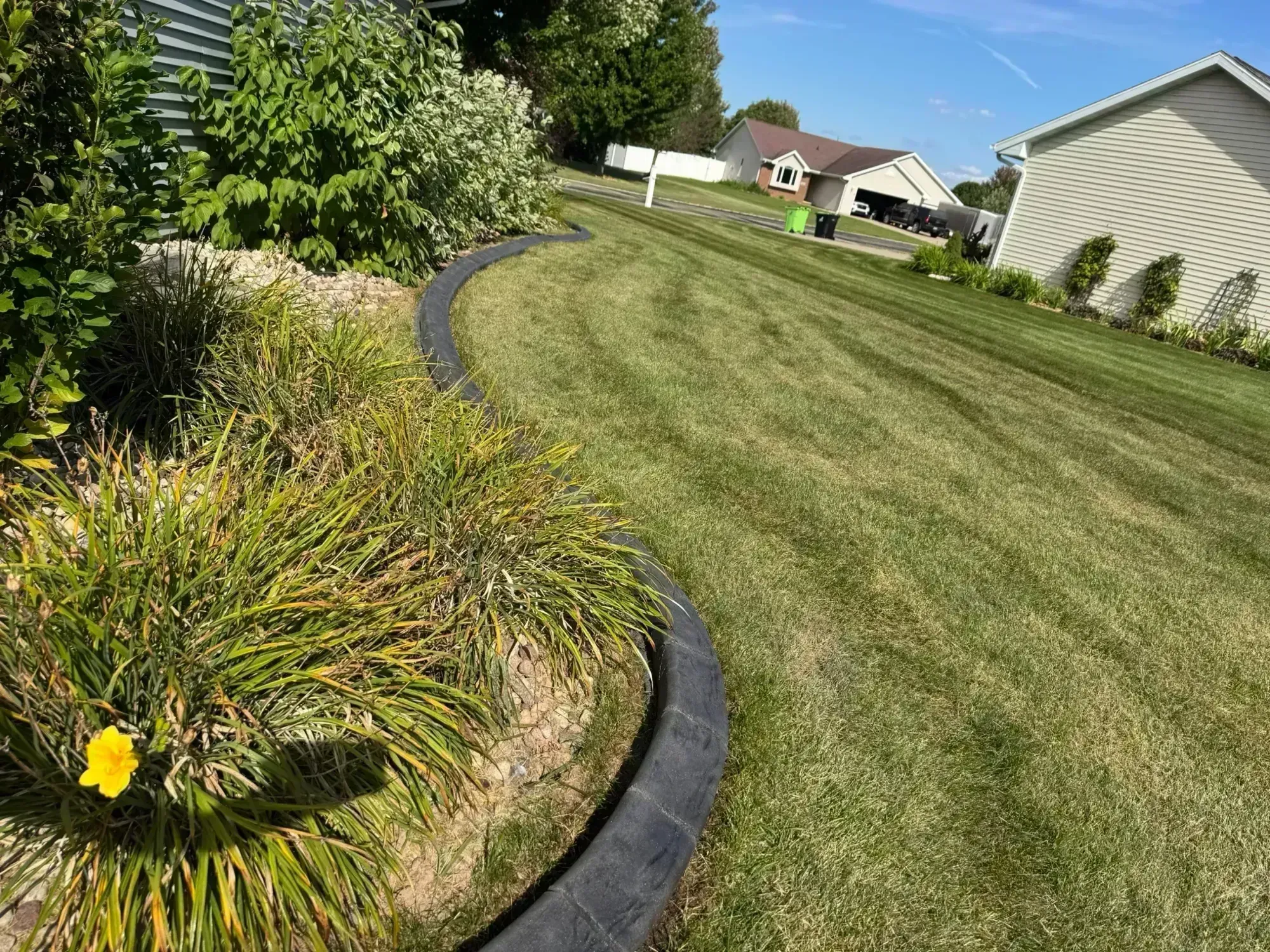 Curved mower curbing around landscape feature